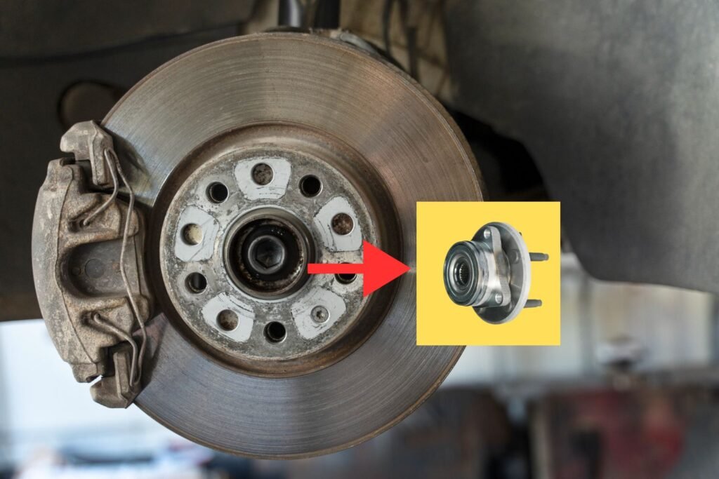 Close-up of a car’s disc brake system and wheel hub, where wheel bearings are housed. Faulty wheel bearings can cause humming noises, uneven tire wear, and vibration in the steering wheel or vehicle body while driving.