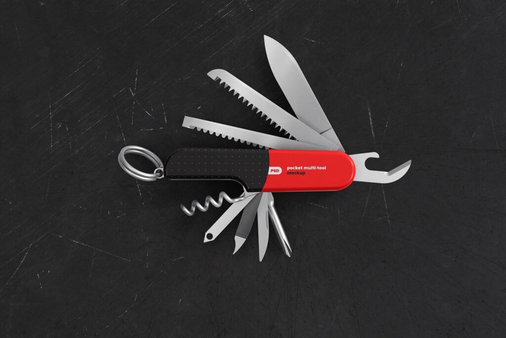 A red and black pocket multi-tool fully opened, showcasing various tools including blades, saws, corkscrew, and screwdrivers, placed on a scratched dark surface.