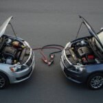 The two cars are parked face-to-face, ready to jump-start.